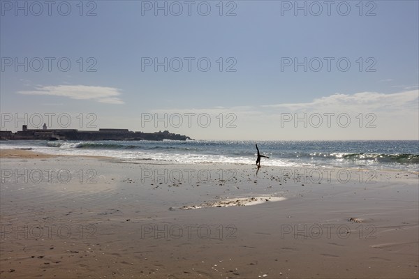 Lonely beach with breaking waves under a sunny sky, Tarifa