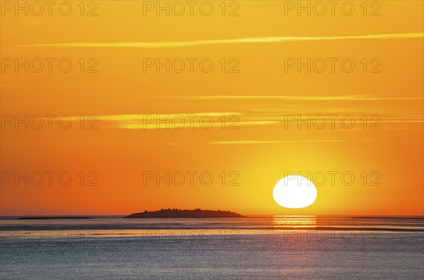 Picturesque, golden, magnificently beautiful sunset over the sea, Langlütjen II island far away,