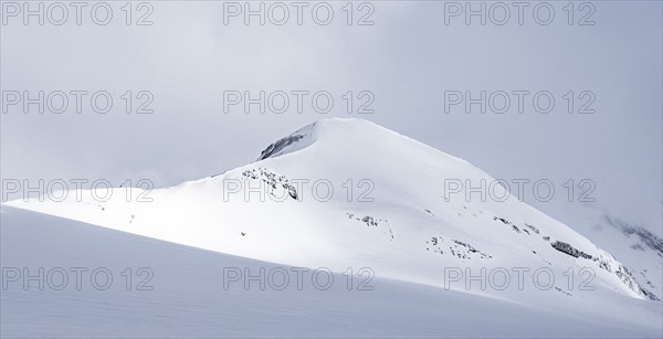 Snow-covered mountain landscape on the Wildhorn, cloudy mood, high tour, Bernese Alps, Bernese