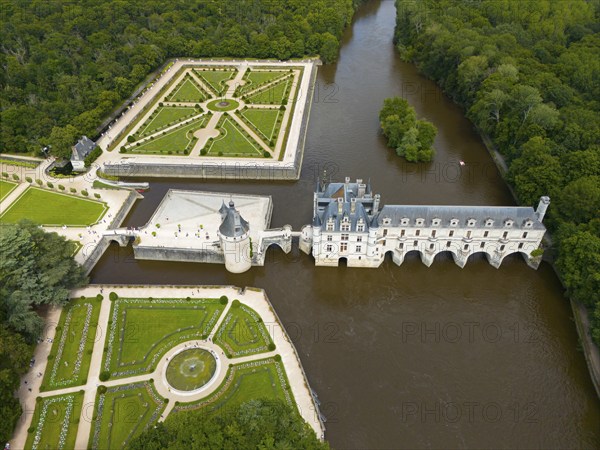 Aerial view of a French castle on the river Cher with neighbouring geometric castle park and green