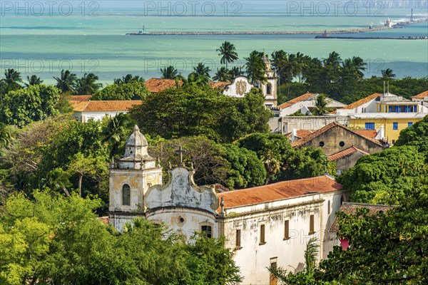 Antique city of Olinda with its mansions and churches among the vegetation facing the sea, Olinda,