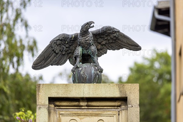 Eagle with globe, sculpture, artwork at a courtyard entrance in Stuttgart, Baden-Württemberg,