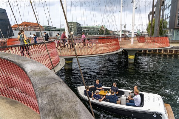 Cyclists on the Cirkelbroen cycle and pedestrian bridge, over the harbour, in the Christianshavens