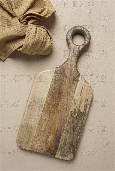 Cutting board, wooden, rectangular shape, with handle, with kitchen towel, top view, no people
