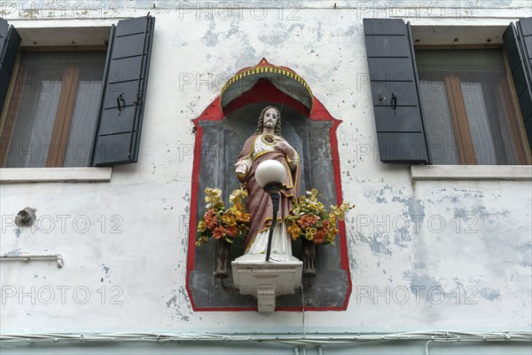 Christ figure with canopy on a house, Burano, Venice, Veneto, Italy, Europe