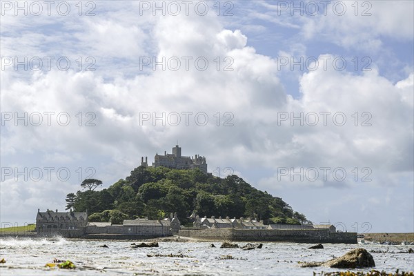 Old castle complex of St Michael's Mount on a hill by the sea, cloudy sky, Cornwall, Great Britain