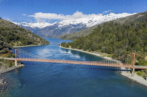 Aerial view of famous orange suspension bridge Puente General Carrera, bridge spans the connection