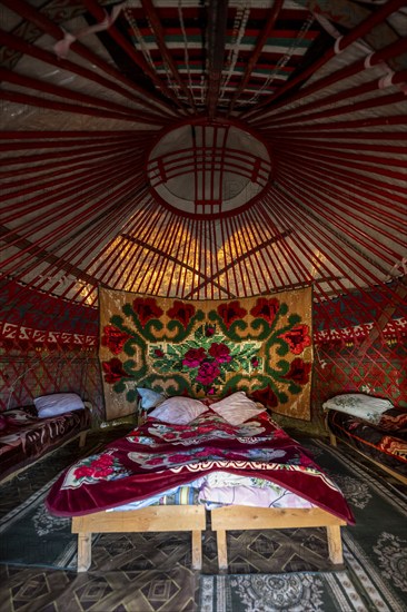 Traditional Kyrgyz yurt for overnight accommodation for tourists, with four beds and carpets, Naryn