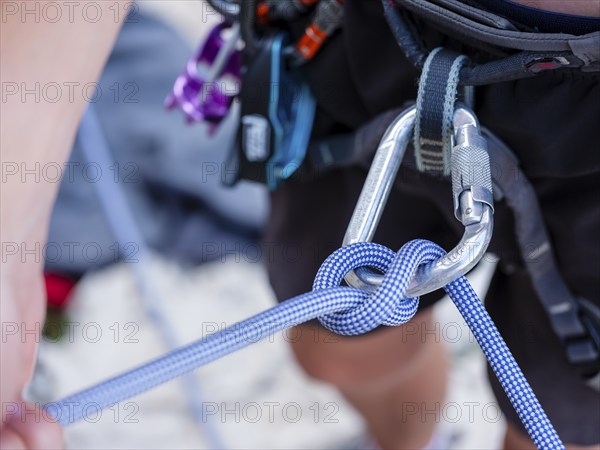 Climbing rope with half-mast safety device in carabiner, Belove Stene climbing area, island of Krk,