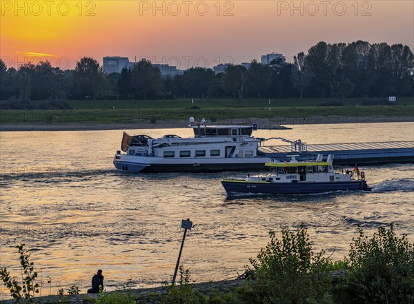 Cargo ship on the Rhine near Düsseldorf, water police boat, North Rhine-Westphalia, Germany, Europe