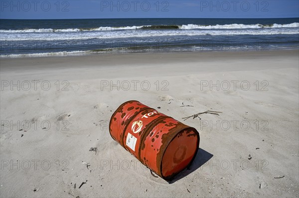 Washed up oil drum on the beach, Loango National Park, Parc National de Loango, Ogooué-Maritime