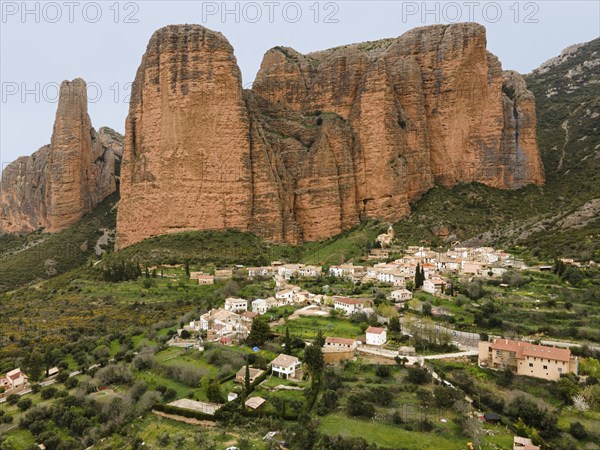 View of a small village surrounded by huge rocks and green landscape that gives a quiet and rural