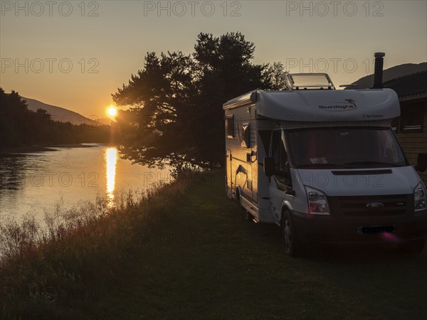 Camper van parked for the night at river bank of river Lagen, at sunset, some km south of Dombas,