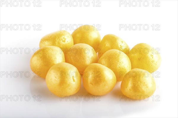 Heap of yellow hard sugar candies isolated on white background