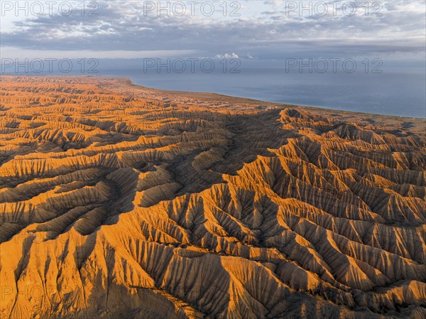 Landscape of eroded hills at Lake Issyk Kul, Badlands at sunrise, aerial view, Canyon of the
