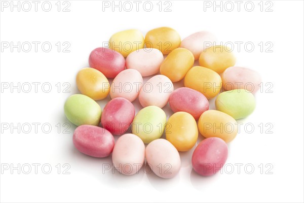 Heap of multicolored caramel candies isolated on white background. close up, side view