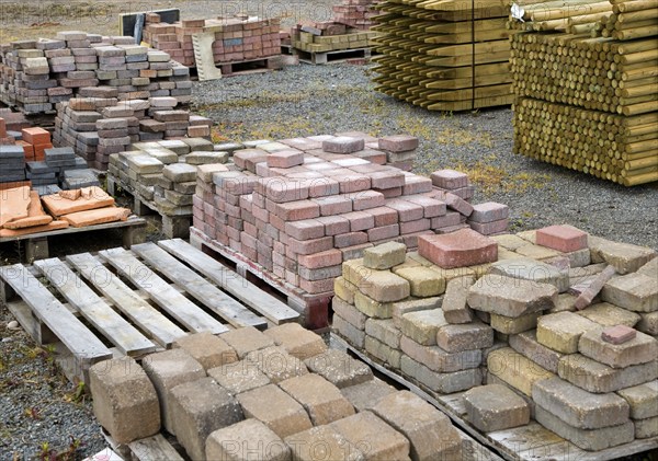 Clay bricks piled up in builder's yard, UK