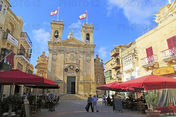 Basilica church and cafes in Saint George's square, Plaza San Gorg, Victoria Rabat, island of Gozo,