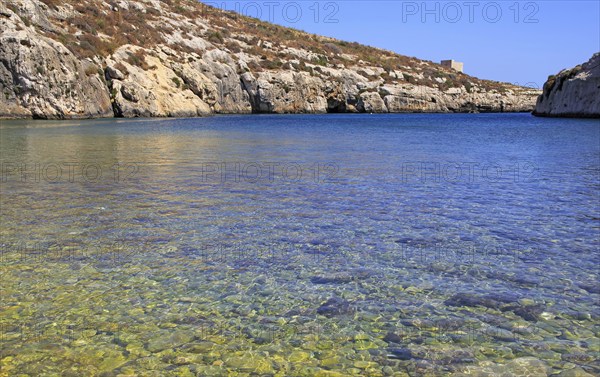 Shoreline clear blue sea water, Mgarr ix-Xini coastal inlet, island of Gozo, Malta, Europe
