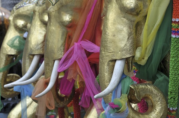 Teak elephants decorated with lucky bows, Erawan Shrine, Bangkok, Thailand, Asia