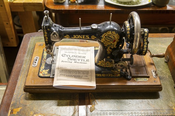 Jones Sewing Machine Company Family Cylinder Shuttle model with instruction manual on display in