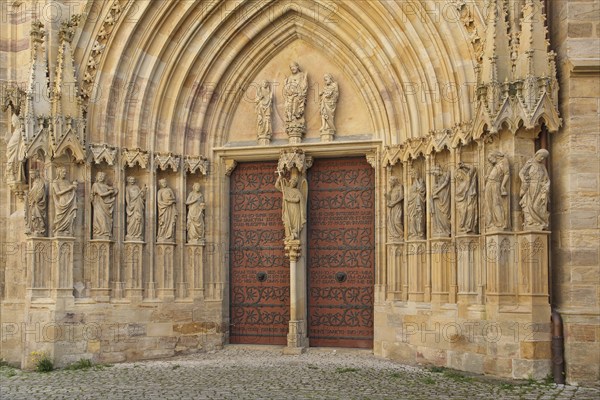 Sculptures on the Virgin Mary portal with tympanum and Archangel Michael, Gothic church portal,