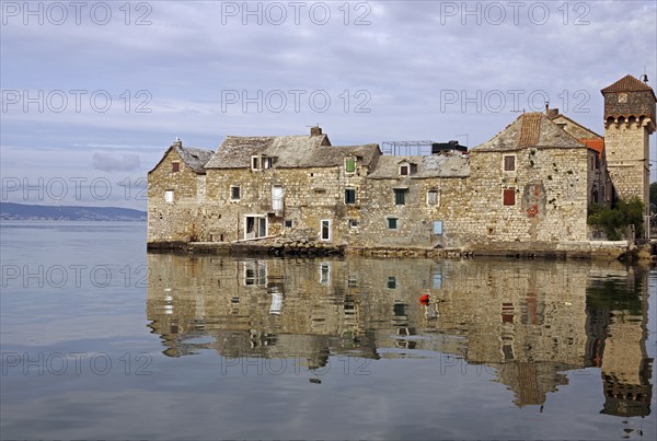 Old fortification from the Mediterranean reflected in the water, town of Kastela, Split, Dalmatia,