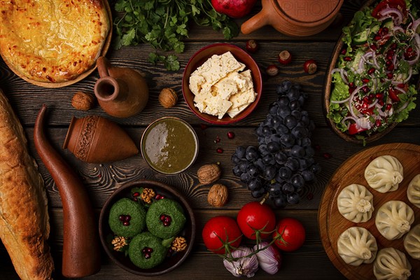 Traditional Georgian table, top view, Khinkali, Phali, Shoti, Khachapuri, Sauces, Fruits, nuts,