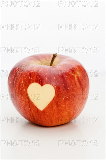 An apple with a heart, carved, symbol of love, Valentine's Day, Mother's Day, studio