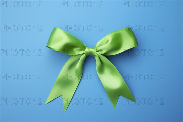 Green silk ribbon on blue background. KI generiert, generiert AI generated