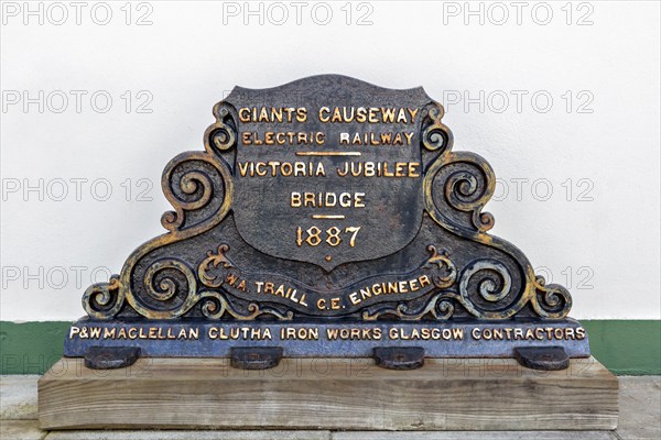 Historic metal plaque with inscription on the 1887 engineering project, Giant Causeway