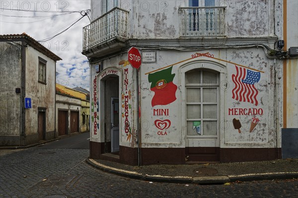 Corner of a street with a small shop and painted signs, deserted and quiet, Fenais da Luz, Sao
