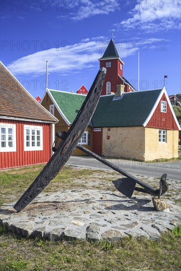 Historic building and anchor in front of blue sky, Museum, Sisimiut, West Greenland, Greenland,