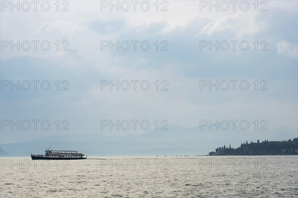 Historic ferry boat in the evening light, tourism, evening mood, sunset, Lake Garda, Malcesine,