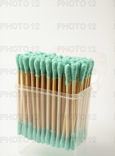 Bamboo cotton swabs, green, on a light background, in a package