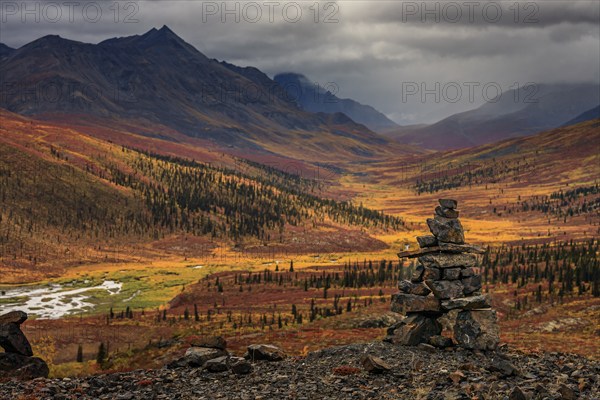Autumn coloured tundra, mountains, clouds, Inukshuk, Tombstone Territorial Park, Dempster Highway,