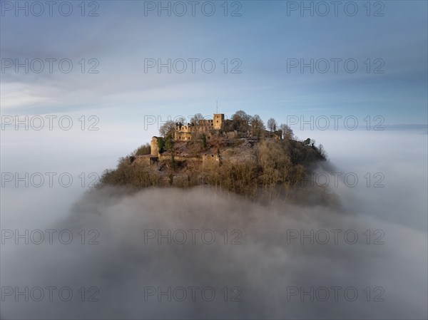 Aerial view of the Hegau volcano Hohentwiel with the upper fortress ruins illuminated by the rising
