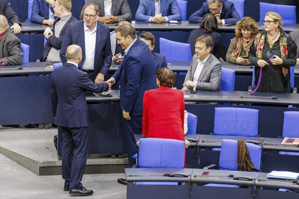 Olaf Scholz (SPD), Federal Chancellor, greets Lars Klingbeil in the plenary chamber in front of the