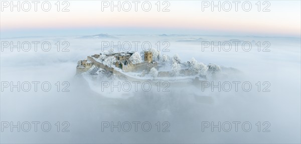 Aerial panorama of the Hegau volcano Hohentwiel with Germany's largest fortress ruins on a cold,