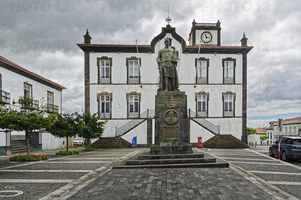 Town square with a statue in front of a historic building with clock tower Largo do Município de