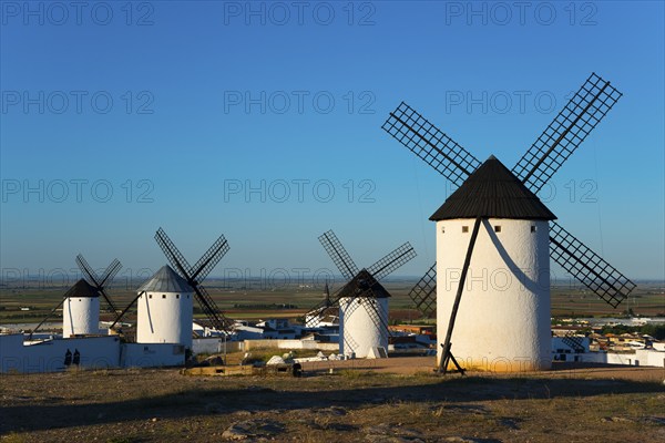 Group of white windmills in front of a vast landscape under a blue sky, Campo de Criptana, Ciudad