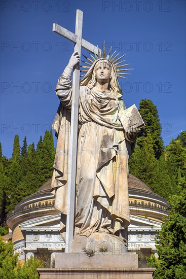 Monumental statue of a saint at the entrance to the Staglieno Monumental Cemetery, Cimitero