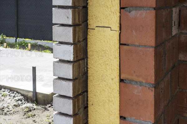 Close up of cavity wall insulation boards fitted in masonry cavities in newly built house used to