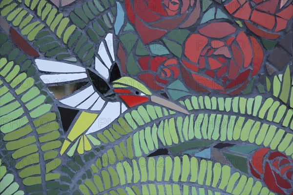 Wall mosaic with hummingbird by Isidora Paz López 2019, one, bird figure, flight, green, flower
