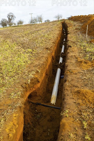 Farm irrigation water supply pipeline excavated in sandy soil, Shottisham, Suffolk, England, UK