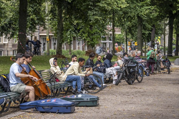 Park at the Hofvijver, opposite the historic Binnenhof, seat of the Dutch government, people taking