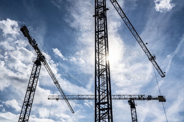 Construction cranes on two large construction sites, construction of office buildings in