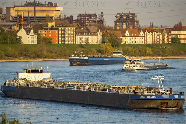 Cargo ships on the Rhine near Duisburg-Laar, houses on Deichstraße, industrial backdrop of the