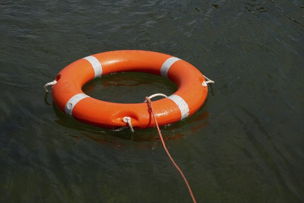 Lifebuoy with lifeline in the water, distress at sea, drowning, accident, danger, shipping,