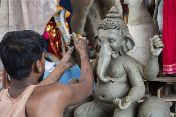Artisan work on idols of the elephant-headed Hindu deity Ganesha at a workshop ahead of the Ganesh